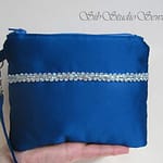 Peacock blue satin clutch style wristlet with silver sparkle trim 